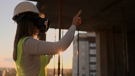 Female-engineer-in-hardhat-with-VR-glasses-designing-construction-project-at-manufacturing-plant